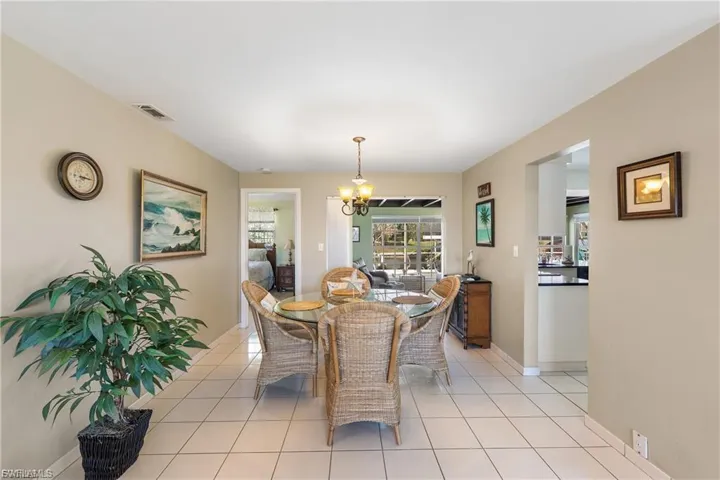 Dining area featuring light tile patterned floors and a chandelier