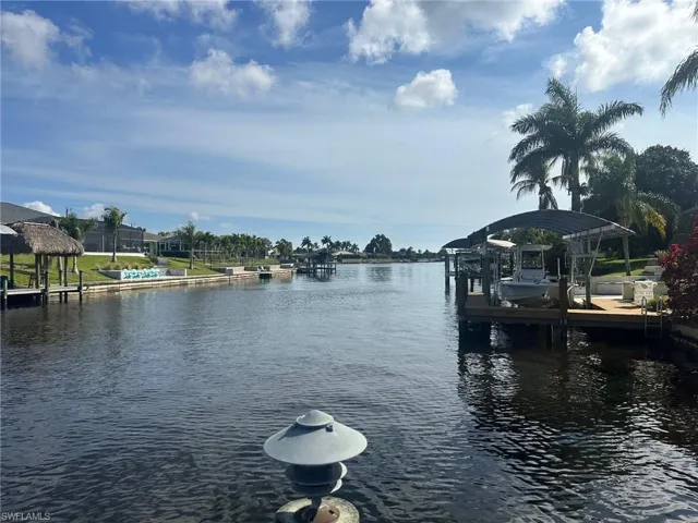 Dock featuring boat lift and a water view