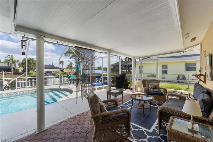 View of patio / terrace featuring a sunroom, glass enclosure, an outdoor pool, a grill, and outdoor lounge area