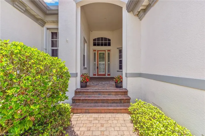 Large entryway with brick pavers & sitting space.