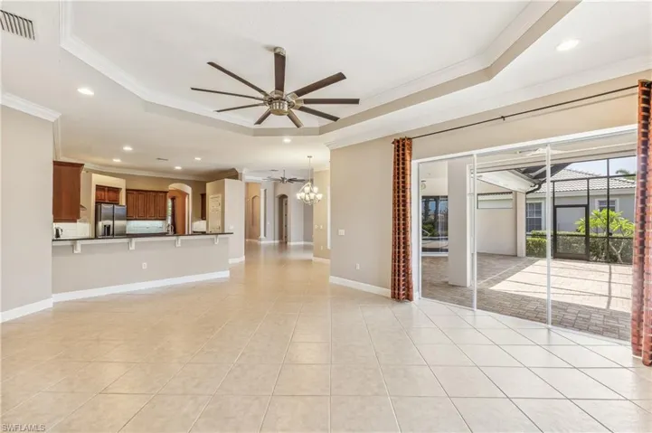 Large family room with access to lanai, view of lovely backyard.