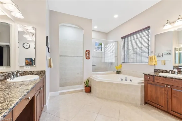 Main bathroom with dual sinks, separate shower and tub.