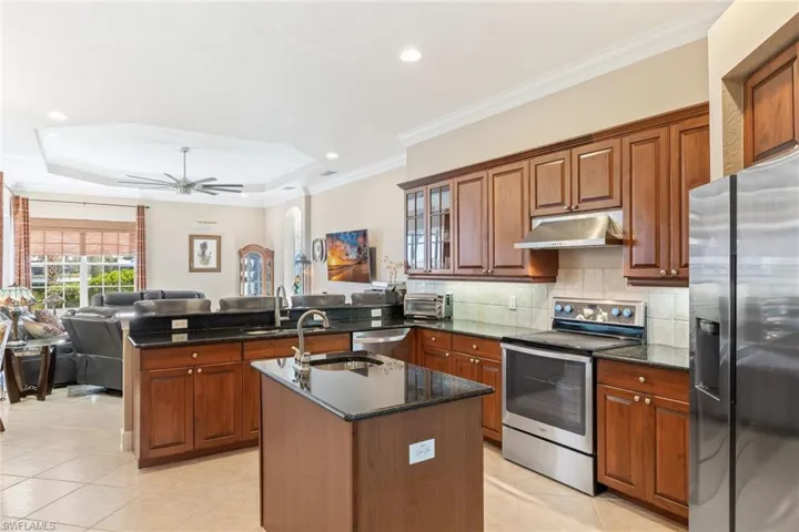 Large kitchen with center island, stainless steel appliances.