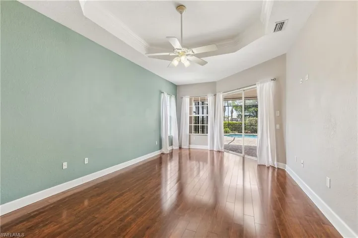 Large main bedroom with a view of the pool.