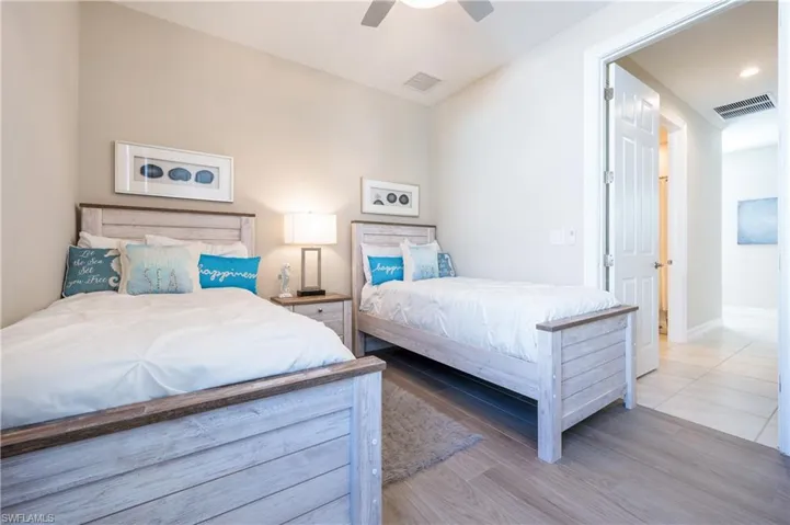 Bedroom with a ceiling fan and wood finished floors