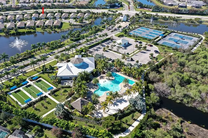 Aerial perspective of suburban area featuring a nearby body of water