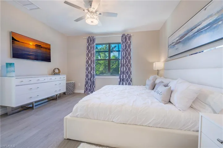 Bedroom with light wood-type flooring and a ceiling fan