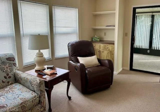 Living area featuring carpet flooring and healthy amount of natural light