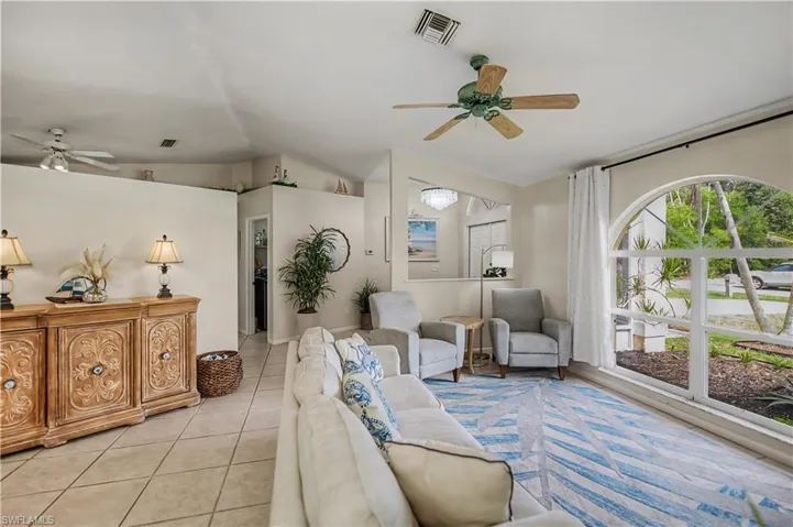 family room and front entrance looking towards hallway to inside laundry room and primary bedroom