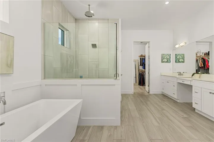Bathroom with vanity and independent shower and bath