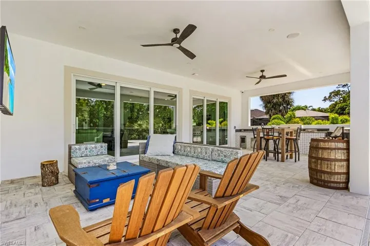 View of patio featuring ceiling fan, outdoor lounge area, and an outdoor bar
