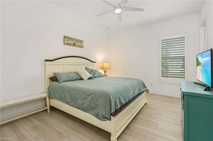 Bedroom featuring ceiling fan and light hardwood / wood-style floors