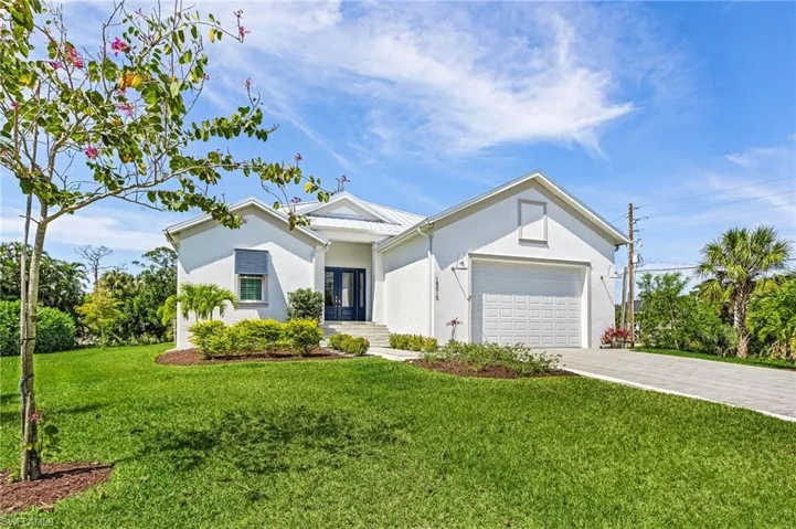 Ranch-style home with a garage and a front yard