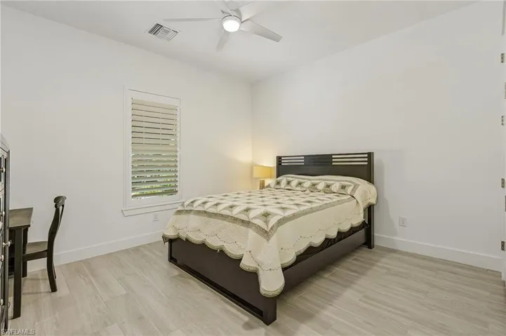 Bedroom with ceiling fan and light hardwood / wood-style flooring