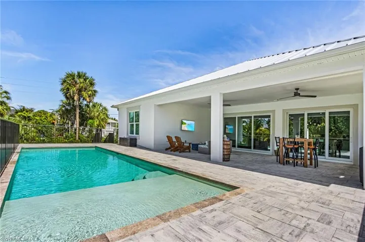 View of pool with ceiling fan and a patio area
