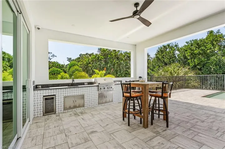 View of patio featuring grilling area, ceiling fan, area for grilling, and sink