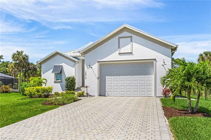 Ranch-style home with a front lawn and a garage