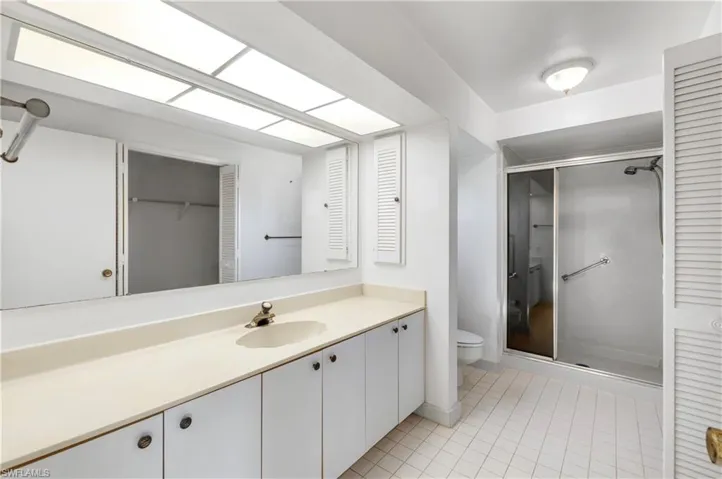 Unfurnished bedroom with access to exterior, carpet flooring, and a ceiling fan