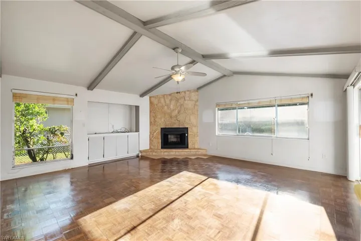 Carpeted empty room featuring a ceiling fan and baseboards