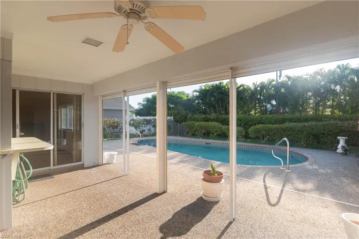 Kitchen featuring a ceiling fan, beam ceiling, white appliances, light countertops, and high vaulted ceiling