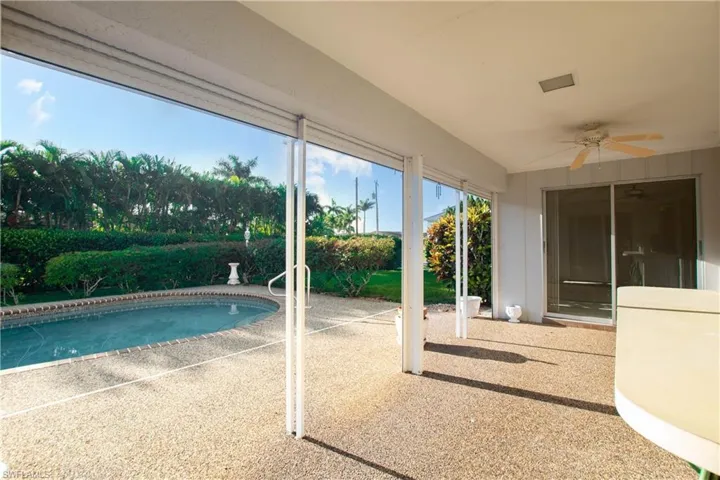 View of swimming pool featuring a ceiling fan and a patio area