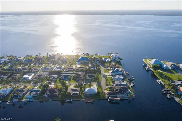 View of property location featuring a nearby body of water and nearby suburban area