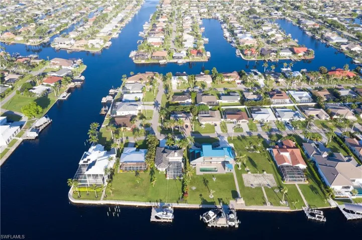 Aerial view of residential area featuring a large body of water