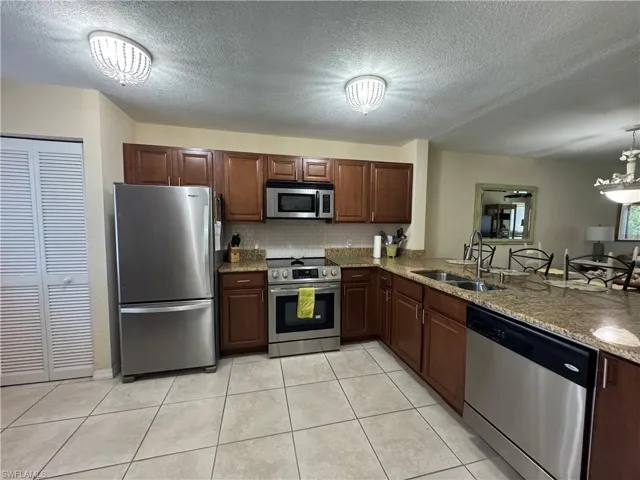 Stainless appliances and tile flooring