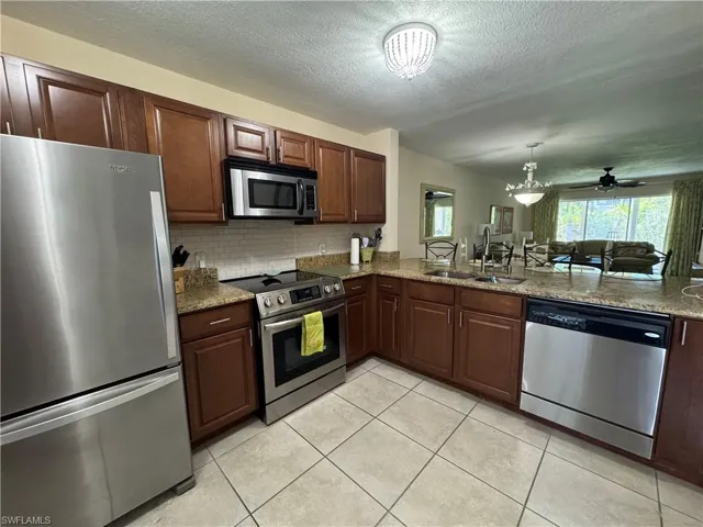 Tiled kitchen with stainless appliances