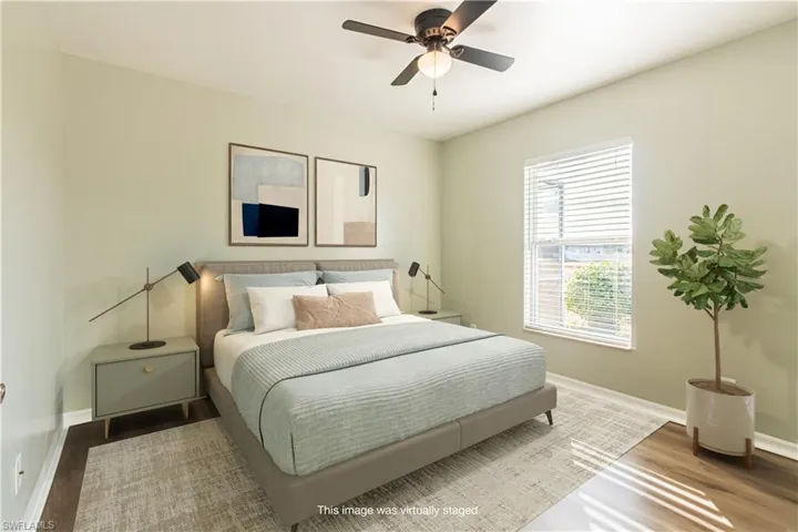 Bedroom featuring ceiling fan Luxury Vinyl Flooring