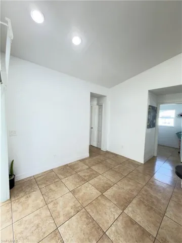 Unfurnished room featuring baseboards and light tile patterned floors