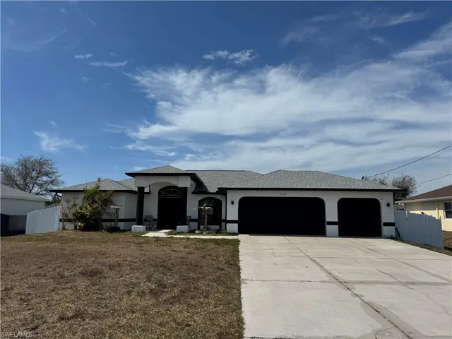View of front of home featuring a garage, stucco siding, concrete driveway, and a shingled roof