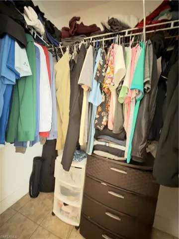 Walk in closet with light tile patterned floors