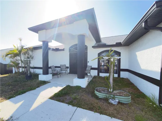 Property entrance featuring stucco siding