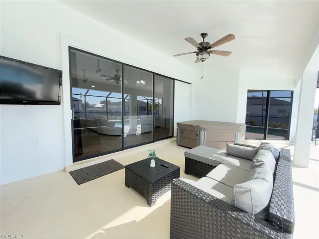 View of patio / terrace with an outdoor living space, a hot tub, and ceiling fan
