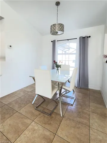 Dining area with light tile patterned floors