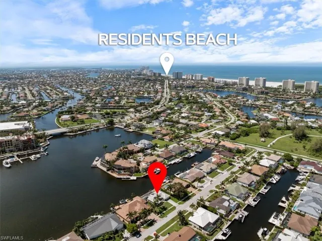 Birds eye view of property with a water view