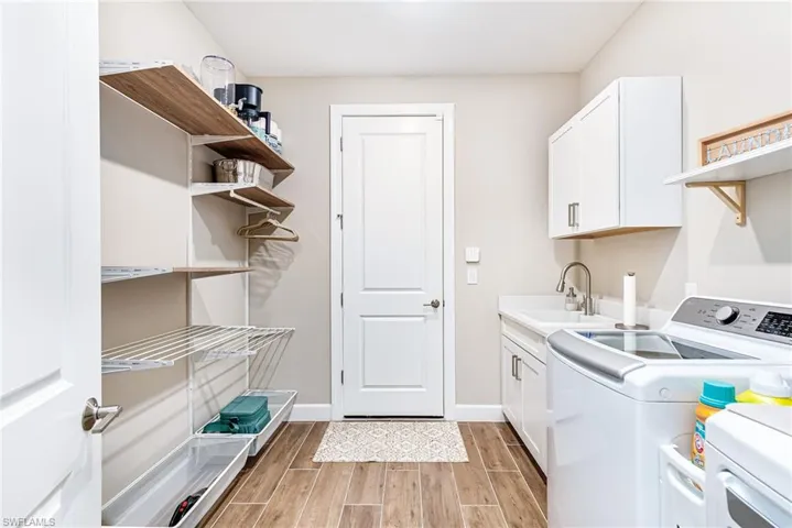 Laundry room with built-in shelving and drying racks