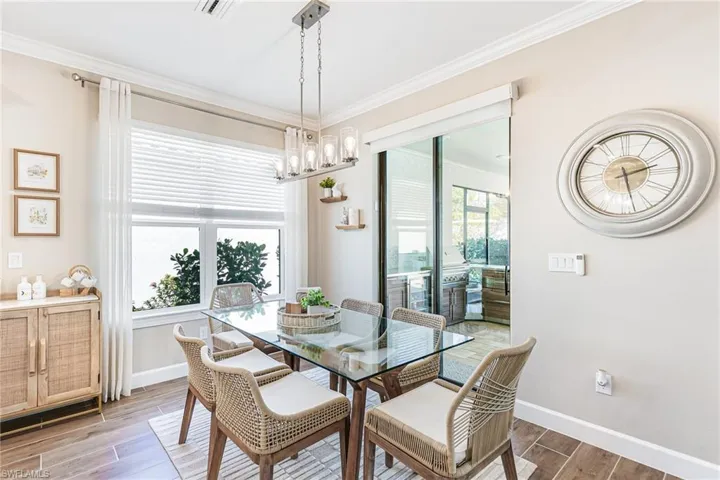 Dining area featuring sliding glass doors to outdoor living & kitchen