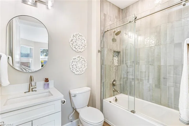 Ensuite bathroom 3 featuring a new custom tiled shower/tub combo with glass door