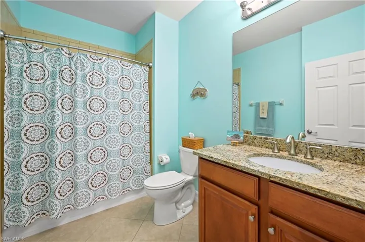 Full bath with tile patterned flooring, and a shower/tub