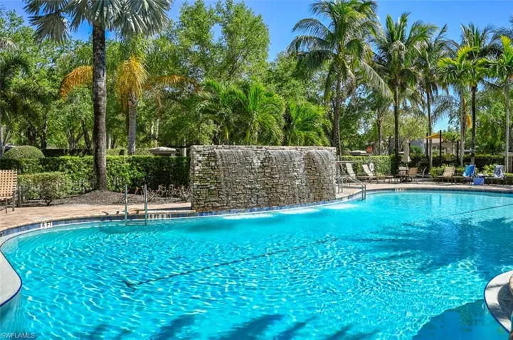 Community pool featuring waterfall