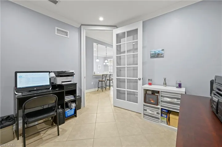 Office featuring tile patterned floors, baseboards, and ornamental molding