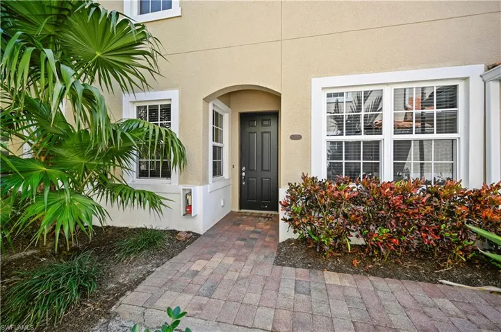Property entrance featuring stucco siding