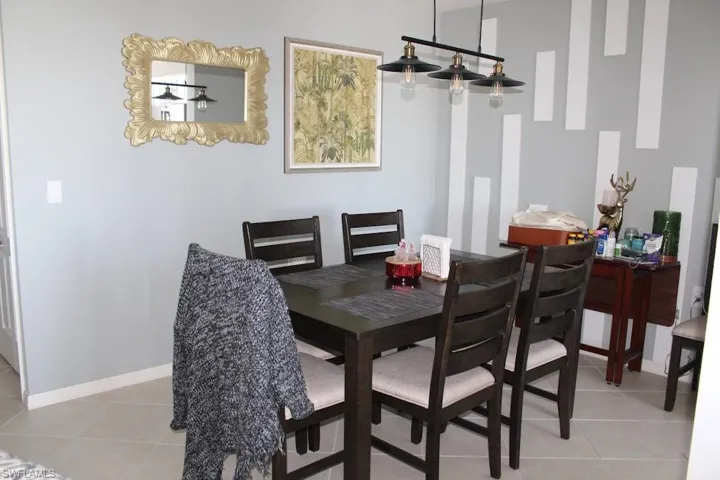 Dining area featuring light tile patterned floors