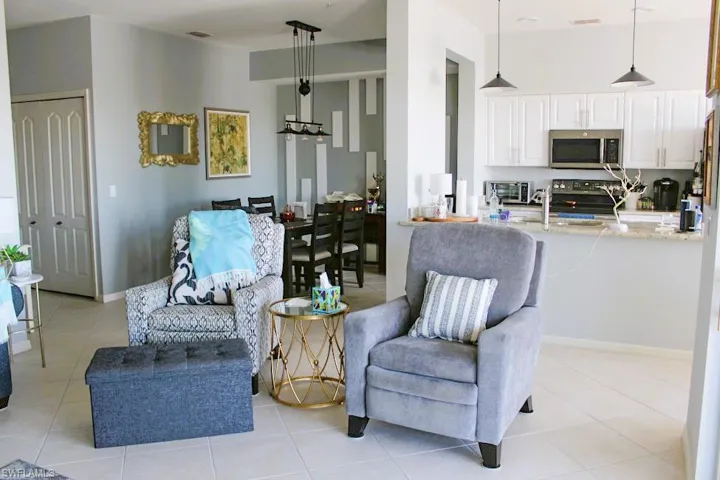 Living area with light tile patterned floors and baseboards