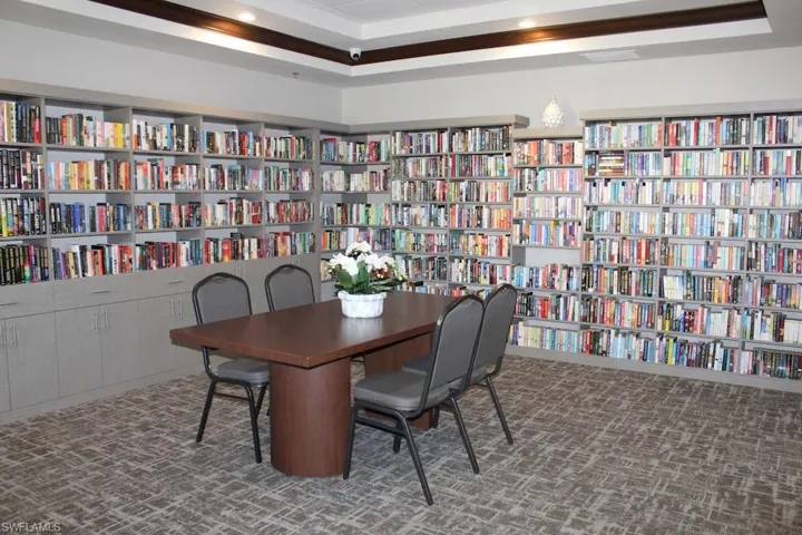 Office area with wall of books and a raised ceiling