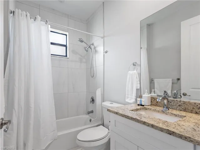 Full bathroom featuring vanity and shower / tub combo with curtain