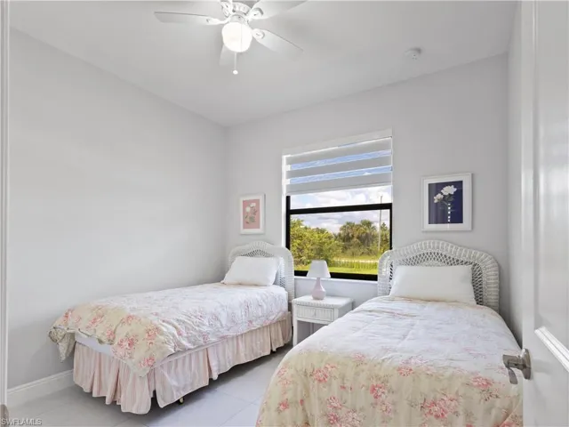 Bedroom with tile patterned floors and ceiling fan