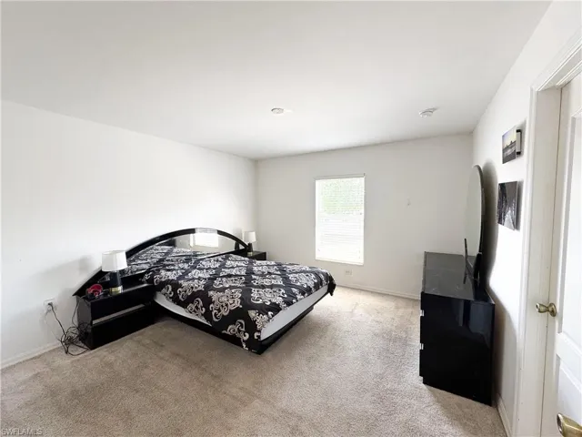 Bedroom featuring baseboards and carpet flooring